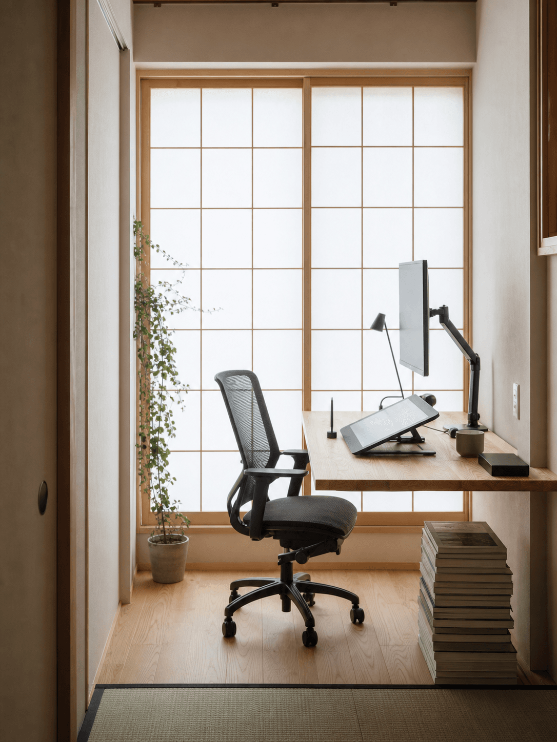 Tokyo designer's compact apartment office — pine desk, shoji light, drawing tablet