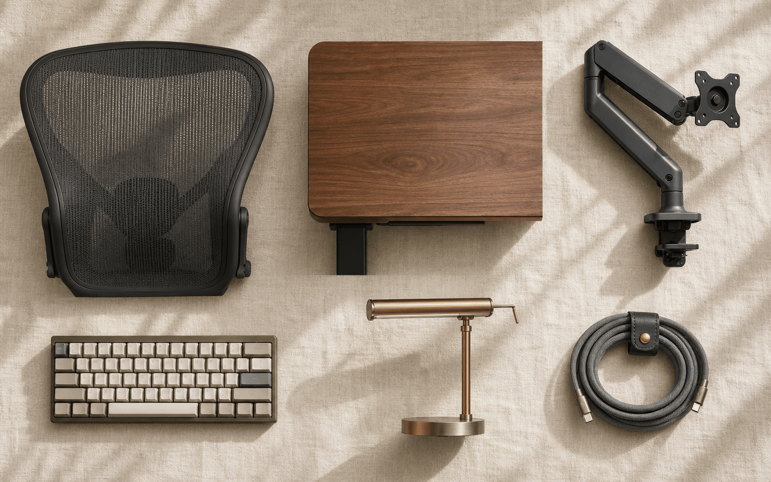 Categories mosaic flat-lay — mesh chair back, desk surface, monitor arm, keyboard, lamp, cable on linen