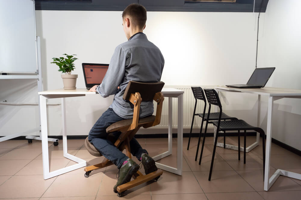 A Man Using Kneeling Chairs